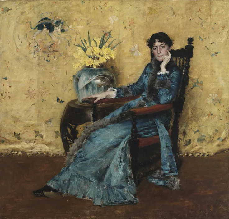 A dark-haired woman in a shimmering blue gown sits in a carved chair against a gold silk wall, a bowl of daffodils beside her.