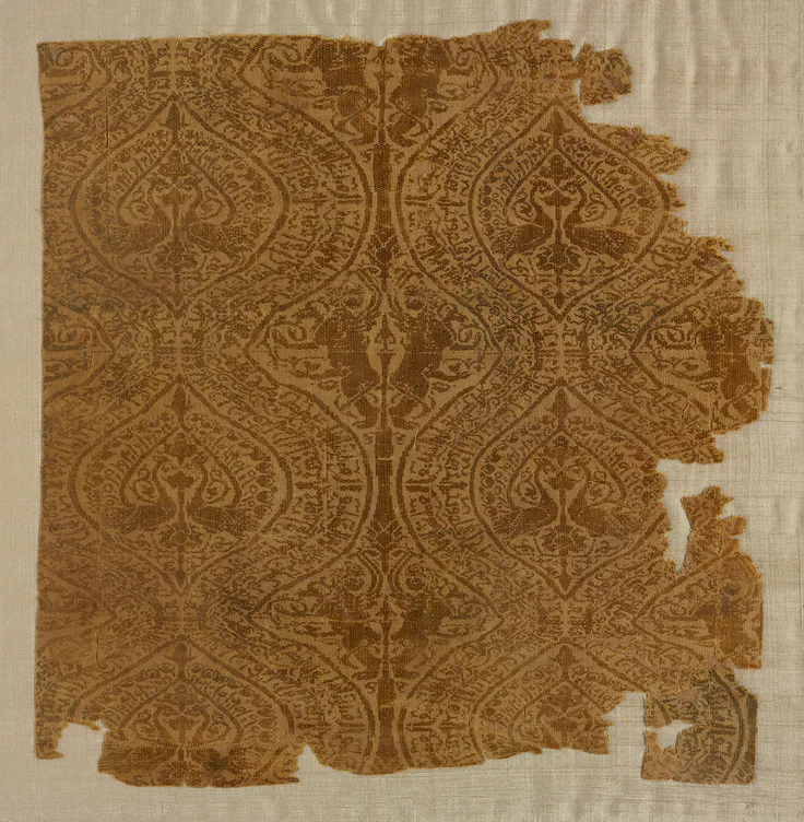 Fragment with peacocks in ogival pattern: silk: plain weave with supplementary weft, 1004–1260 (radiocarbon date, 95% probability).