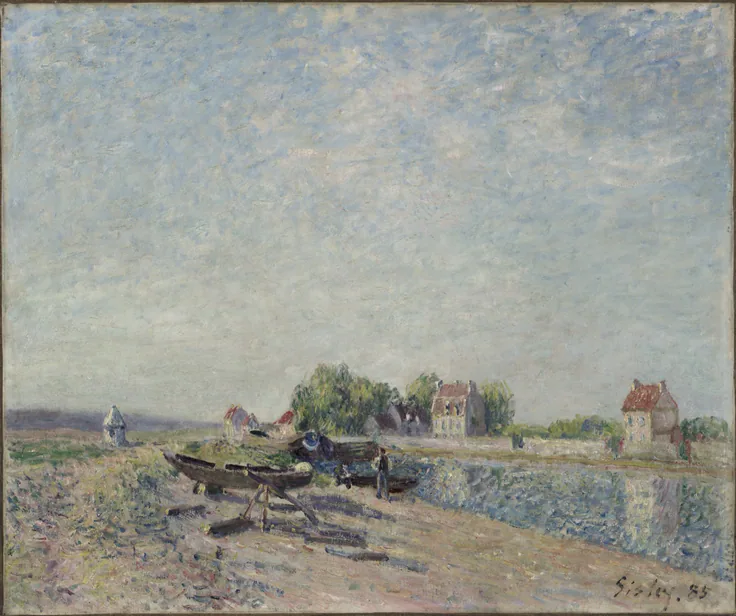 Boats pulled up on a canal bank beside village houses under a high, flickering grey-blue sky; soft afternoon light.