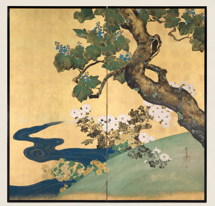 Two-panel gold screen: a twisting paulownia branch over white and yellow chrysanthemums beside a swirling indigo stream.