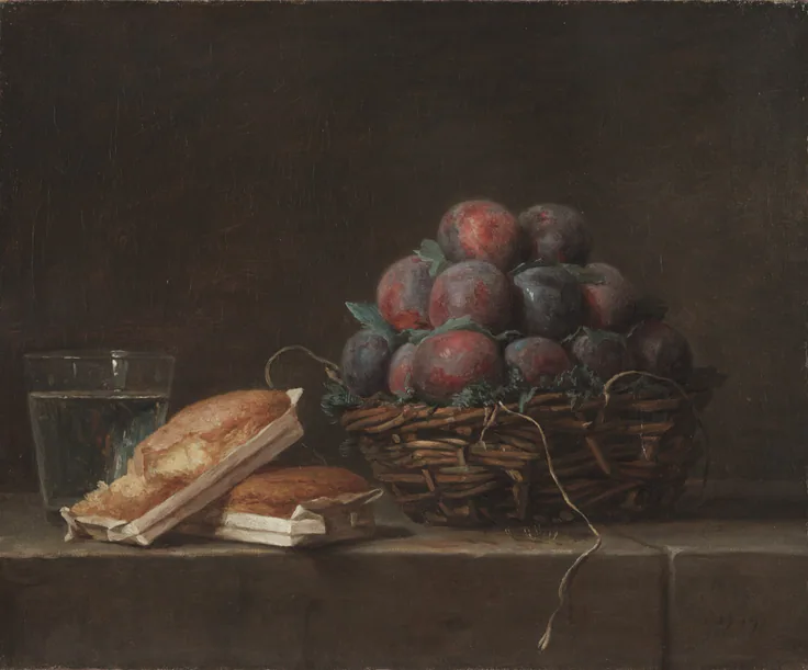 A wicker basket of dusky purple plums beside a glass of water and two small loaves on a stone ledge; soft brown light.