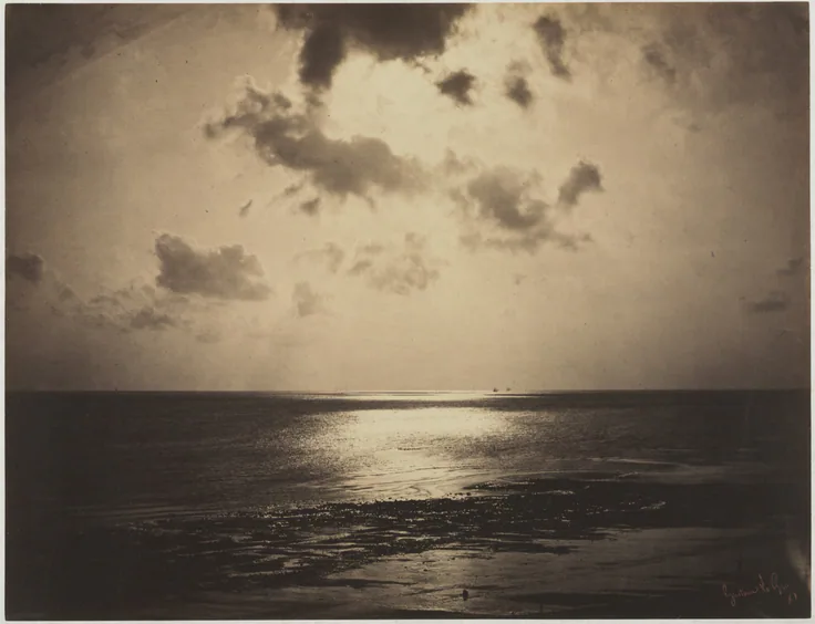 Sun breaks through dark clouds onto a calm sea, laying a bright path of light across the water; deep sepia tones.