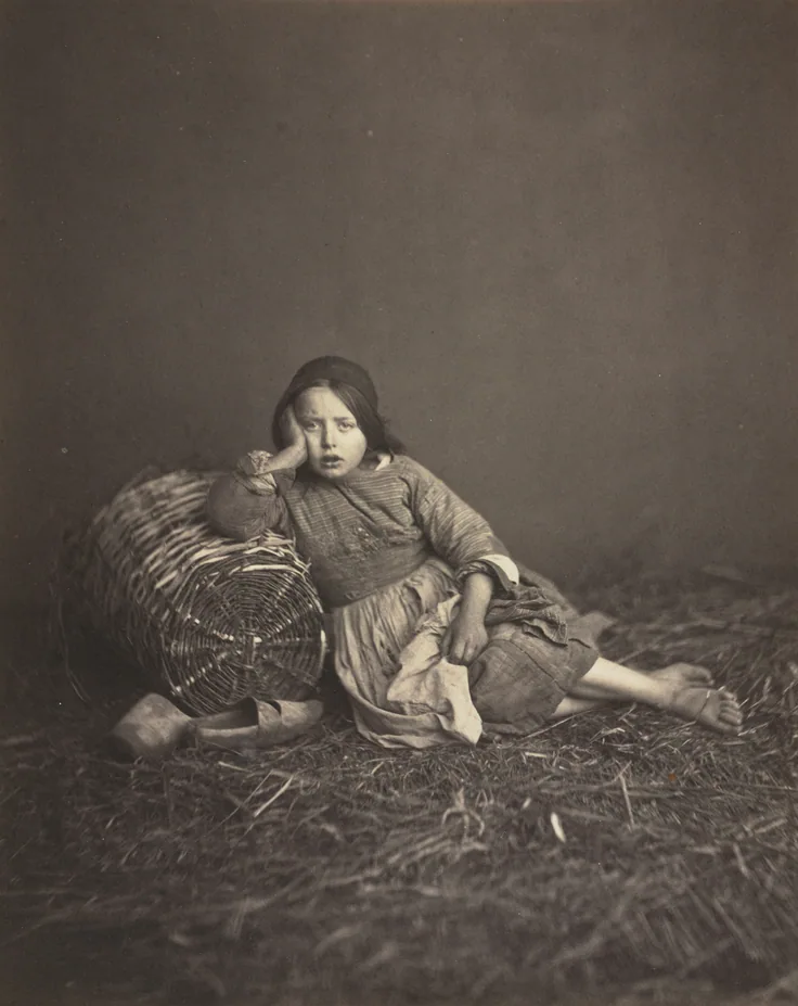 Young Girl Seated on Straw, Leaning on a Basket: albumen print from wet collodion negative by Edmond Bacot, 1862.