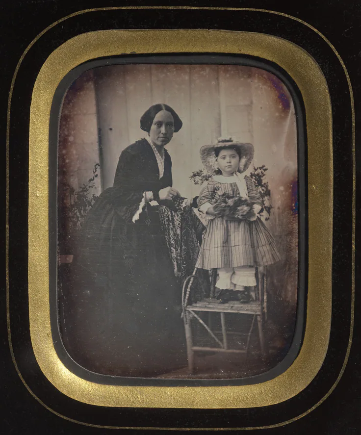 Child Standing on a Chair Holding Flowers, with Mother: daguerreotype, quarter-plate, c. 1855.