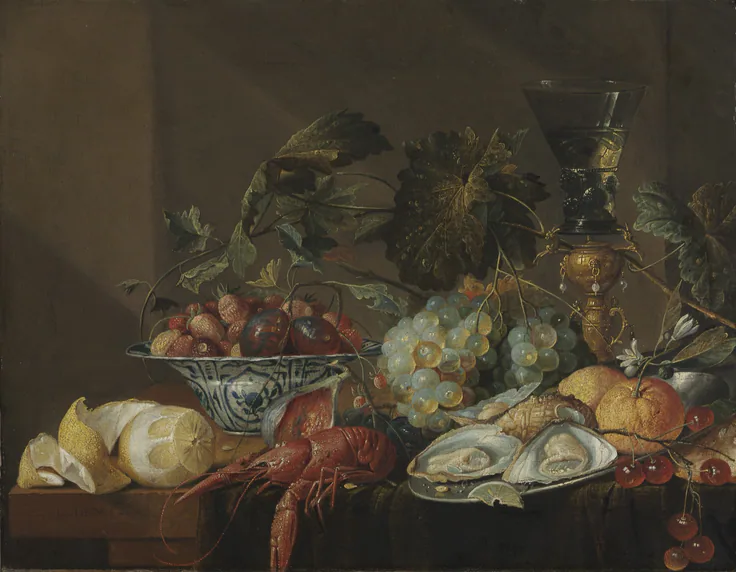 A peeled lemon, red crayfish, oysters, grapes and a porcelain bowl of fruit on a dark ledge with a tall green glass.