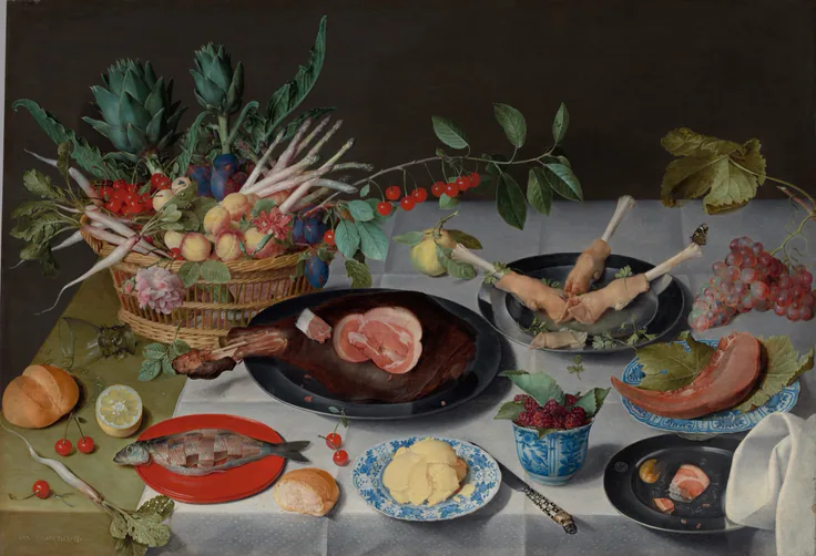 A white-clothed table laid with ham, a red fish, butter, rolls and a basket of fruit and artichokes, seen from above.