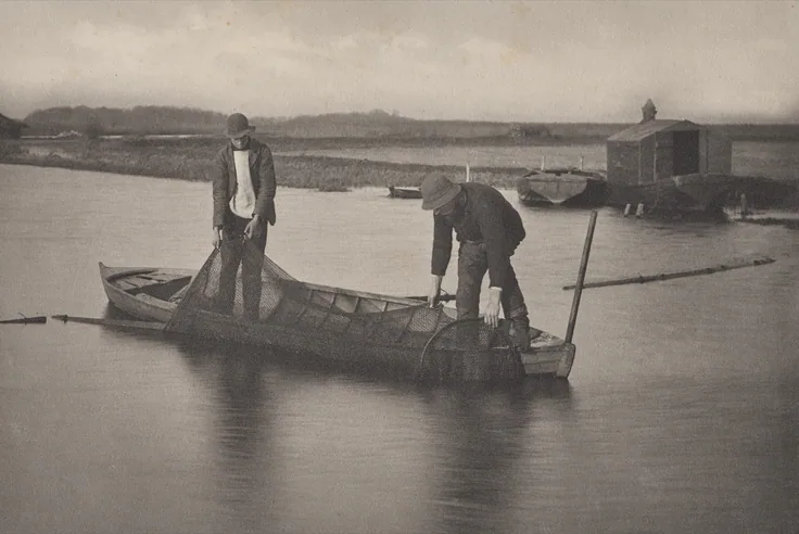 Two men in a flat boat haul a net on a still marsh river, a boathouse behind; muted silver-grey water and sky.